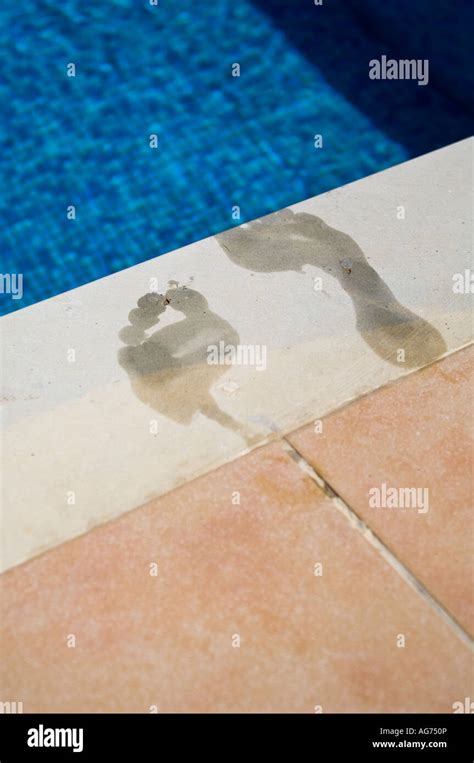 Wet Footprints At Edge Of Swimming Pool Someone Has Just Dived In