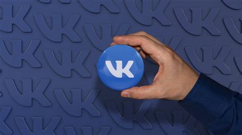 premium photo a hand holding an vkontakte glossy badge on blue russian social network