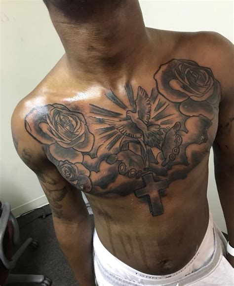 A Man With A Cross And Roses Tattoo On His Chest
