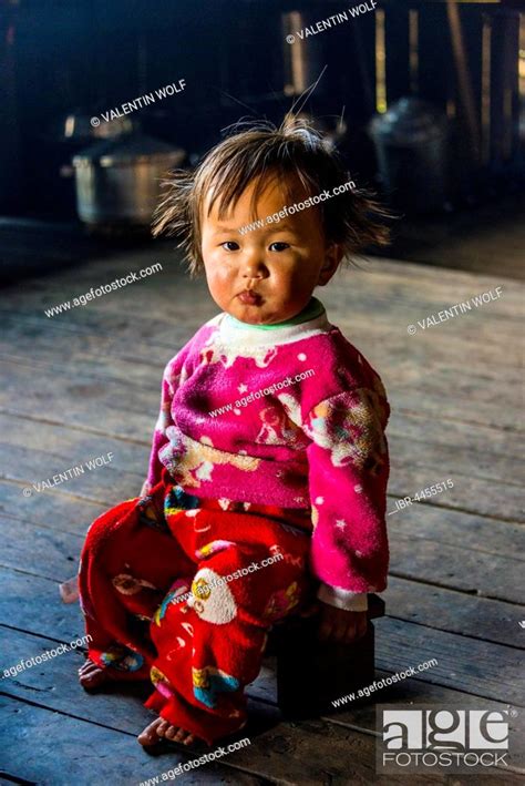 Little Girl Sits On Stool In Hut Palaung Hilltribe Palaung Village In