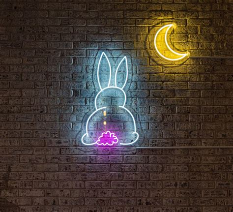 Wall Decorated With A Cute Rabbit Neon Sign With The Moon Stock Photo