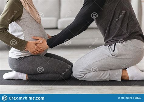 Couples Pregnancy Yoga Cropped Shot Of Muslim Spouses Training Together At Home Stock Image