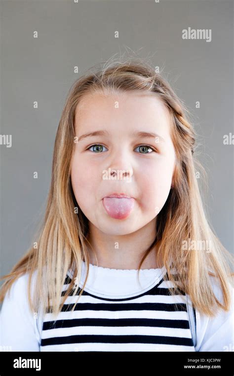 Portrait Of Girl Sticking Tongue Out Stock Photo Alamy