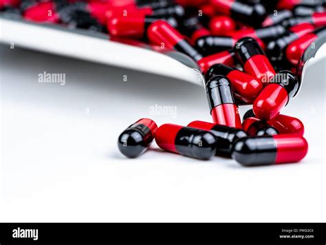 Selective Focus Of Red And Black Capsule Pills On Stainless Steel Drug