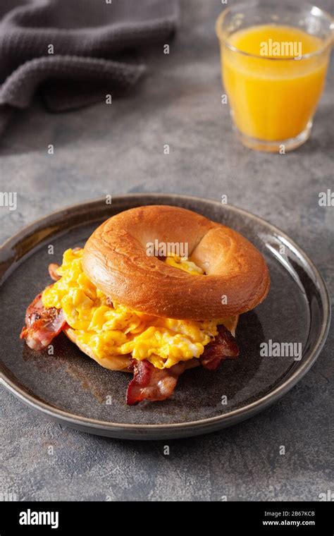 Breakfast Egg And Bacon Sandwich On Bagel With Cheese Stock Photo Alamy