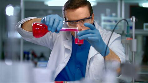 Scientist In Lab Doing Medical Research Laboratory Worker Pour Liquid