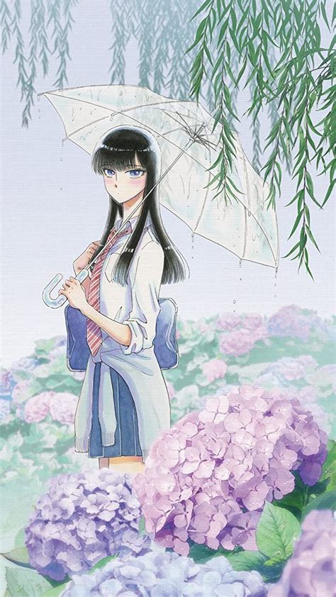 A Woman Holding An Umbrella Standing Next To Purple Flowers