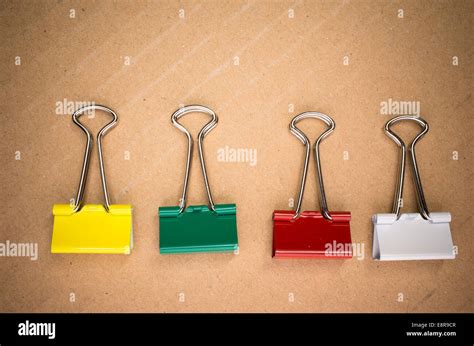 Colored Metal Paper Clips On A Cardboard Background Stock Photo Alamy