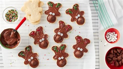 Soft, chewy gingerbread thumbprint cookies rolled in sugar and filled with smooth, rich dark chocolate. Hershey's™ Kisses™ Reindeer Sugar Cookies Recipe - BettyCrocker.com