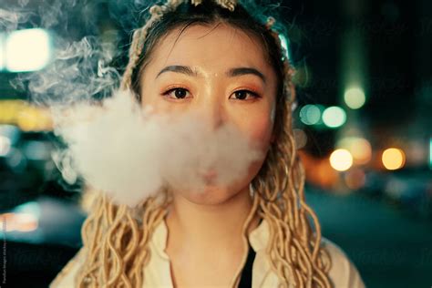 Portrait Of Young Asian Woman Smoking By Stocksy Contributor Pansfun