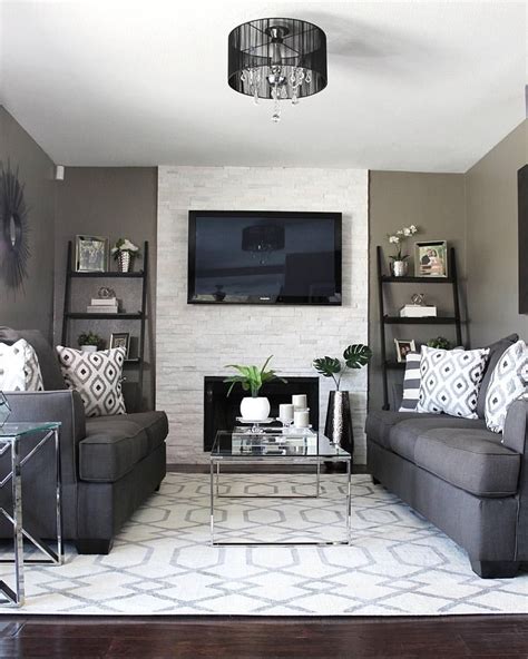 A spacious living room featuring gray couches and a stylish center table set on the rug. Pin by Mvm1950 Massaro on Maria | Living room grey, Brown ...