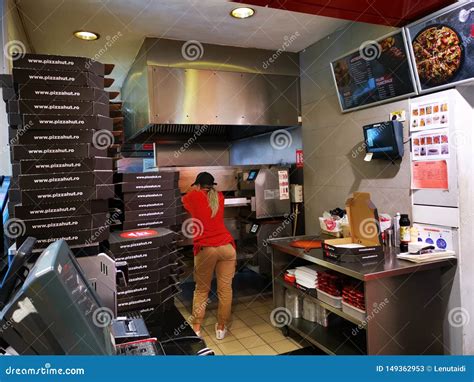 Woman Waiting To Pizza Out Of The Oven At Pizza Hut Deliveryâ€Ž Indoor