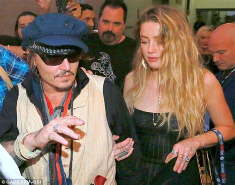 Amber Heard Grips Husband Johnny Depp After Partying At His Rock In Rio