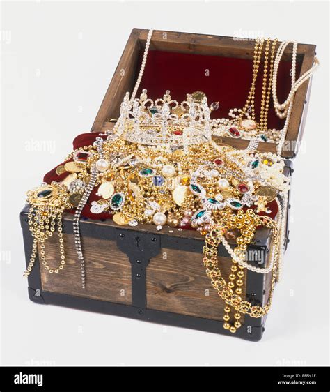 Treasure Chest Full Of Jewellery Gold Coins And A Crown Stock Photo