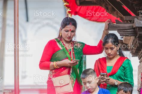 Nepali Hindu Women Using Mobile At Kathmandu Durbar Square In Kathmandu