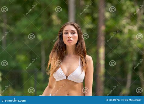 Portrait Of A Beautiful Bikini Model With Blurry Nature Background