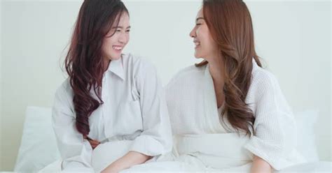 portrait of asian beautiful lesbian woman couple sit on bed at home stock video envato elements
