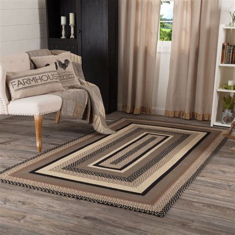 This contemporary rug was created by a renowned designer george terbovich and the hand of a professional is visible in every inch of its fabric. August Grove® Surikova Braided Jute Grey Taupe/Beige/Black ...
