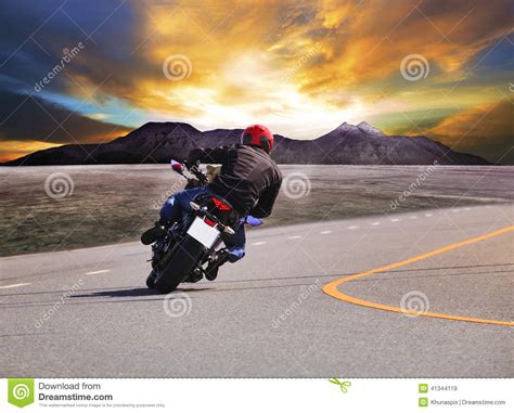 Rear View Of Young Man Riding Motorcycle In Asphalt Road Curve W Stock