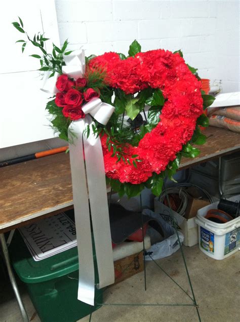 A Beautiful Heart Made Using Red Carnations Accented With A Bundle Of