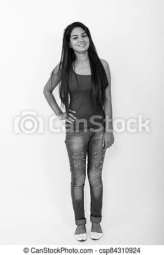 Full Body Shot Of Young Happy Indian Woman Smiling While Standing And Posing Against White