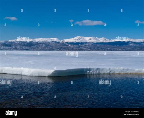 Snowy Mountains At Frozen Lake Laberge Yukon Canada Stock Photo Alamy