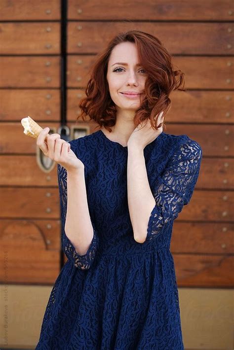beautiful woman holding an ice cream and looking at camera by stocksy contributor amor