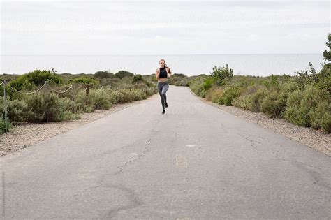 Fit Woman Running At The Beach By Stocksy Contributor Curtis Kim Stocksy