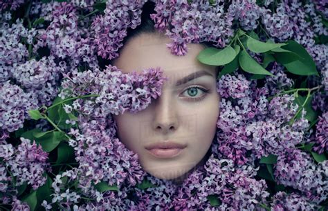 Face Of Woman Surrounded By Purple Flowers Stock Photo Dissolve