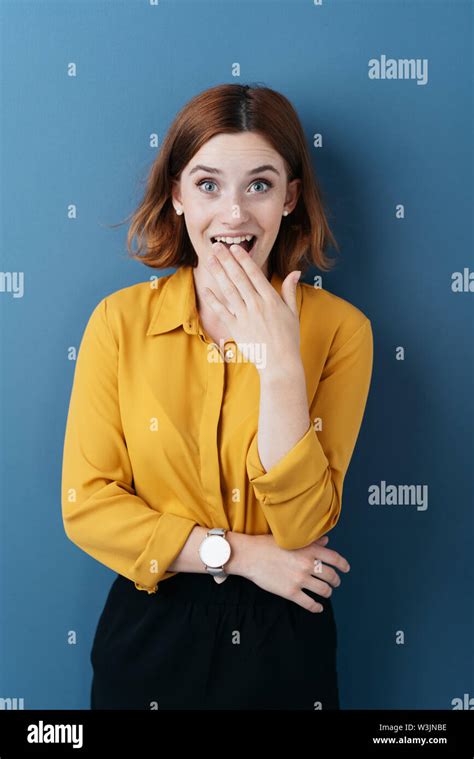 Shocked Excited Young Woman Holding Her Hand To Her Open Mouth As She