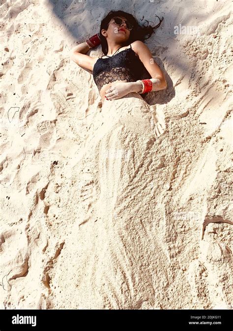 High Angle View Of Woman Buried In Sand At Beach Stock Photo Alamy
