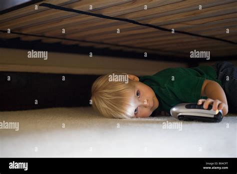 Boy Hiding Under Bed Stock Photo Royalty Free Image 17308224 Alamy