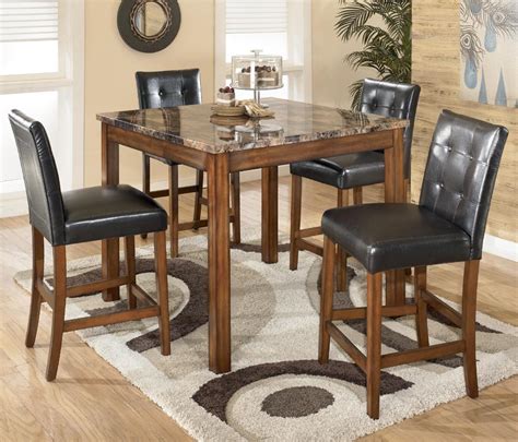 Benchcraft Theo 5 Piece Square Counter Height Table Set With Bar Stools