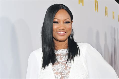 garcelle beauvais wears leather pants and sheer lace corset style and living