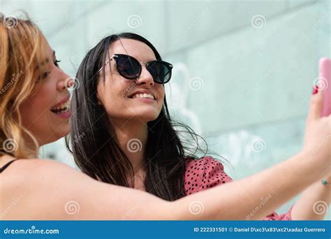 Two Cheerful Girlfriends In Summer Clothes Taking A Selfie Outdoors Stock Image Image Of