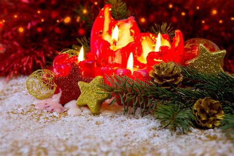 Four Red Advent Candles With Christmas Decoration And Snow Stock Image