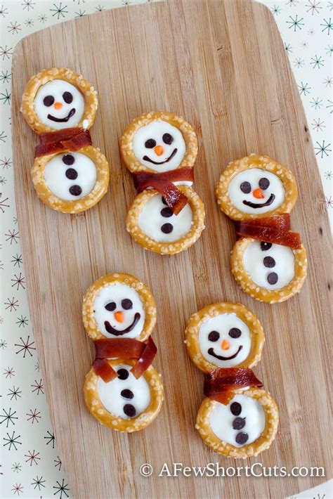 Whether you're feeding kids or adults, everyone loves party appetizers you can eat with your fingers. Simple Pretzel Snowmen | Recipe | Fun snacks for kids, Christmas food gifts, Theme snack