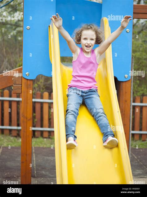 Young Girl On Slide In Playground Stock Photo Alamy