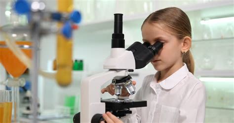 Child Using Microscope In School Chemistry Lab Student Studying