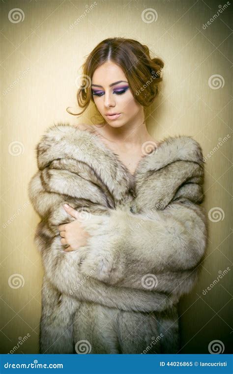 Attractive Young Woman Wearing A Fur Coat Posing Provocatively Indoor Portrait Of Sensual