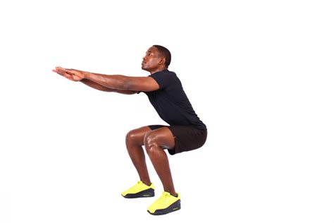 Athletic Man Doing Air Squats Lower Body Exercise