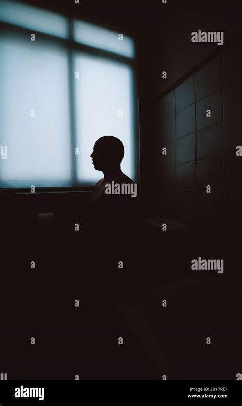 Silhouette Of Man Sitting In Bathroom Stock Photo Alamy
