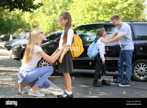 Parents saying goodbye to their children near school Stock Photo - Alamy
