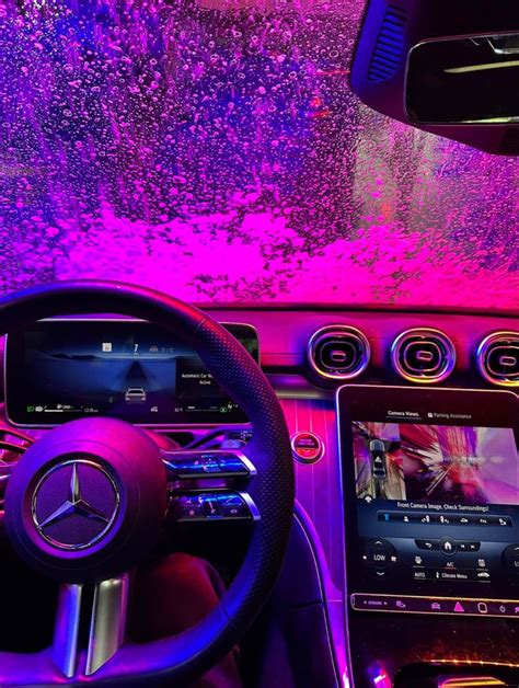 The Interior Of A Car With Purple Lighting