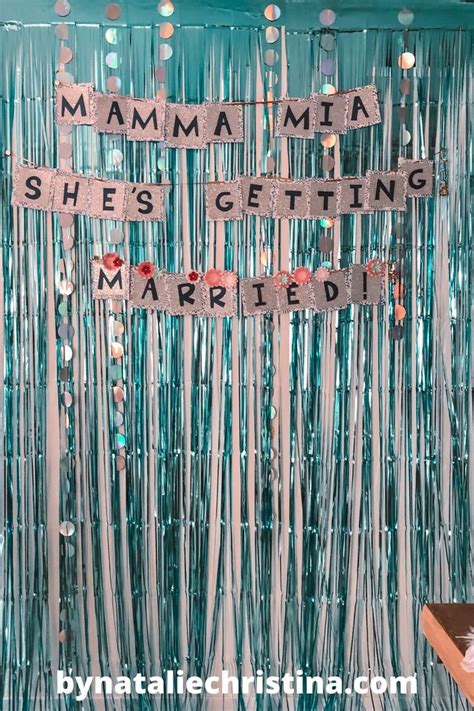 A Party Backdrop With The Words Mamma Shes Getting Married And Streamers