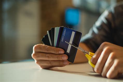 Letting credit card customers pay back specific purchases encourages borrowers to go beyond the minimum, says research by michael norton and colleagues. Young Man Cutting Credit Card With Scissorsman Is Destroying Credit Cards Because Of Big Debt ...