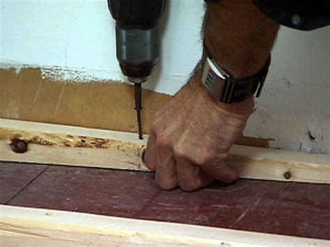 Raise the lower end of the level until the bubble is centered, then measure the distance from the bottom of the level to the floor to find the depth of the dip. How to Level a Floor | how-tos | DIY