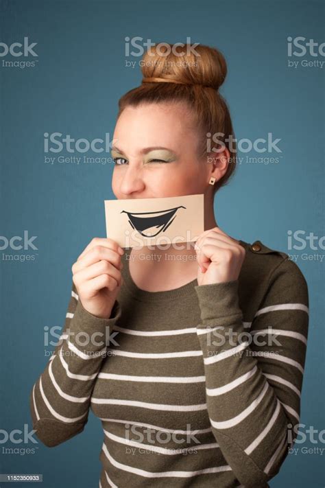 Happy Cute Girl Holding Paper With Funny Smiley Drawing Stock Photo