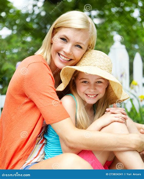 summertime bonding cute litte girl sitting on the grass outdoors with her mom stock image