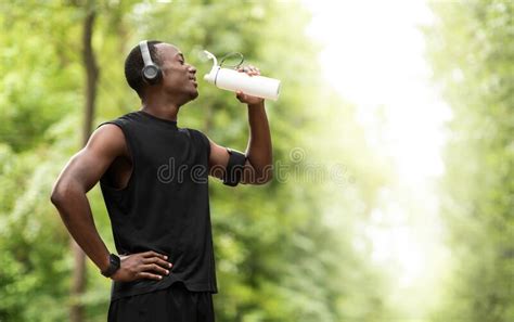 African Sportsman Drinking Water Having Break During Exercising Stock